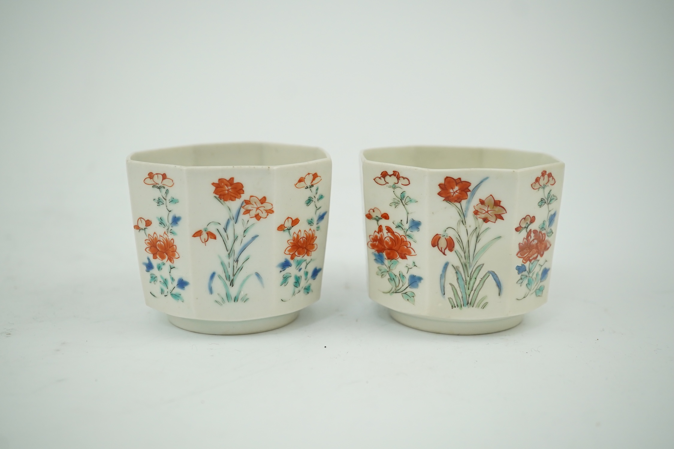 A pair of Japanese kakiemon octagonal porcelain cups, probably Edo period, 5.5cm high. Condition - one restored the other hairline cracks